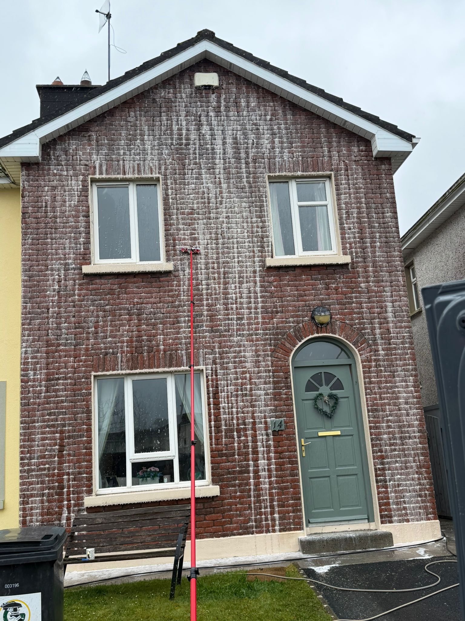 Brick facade soft washing with treatment foam on a Galway property